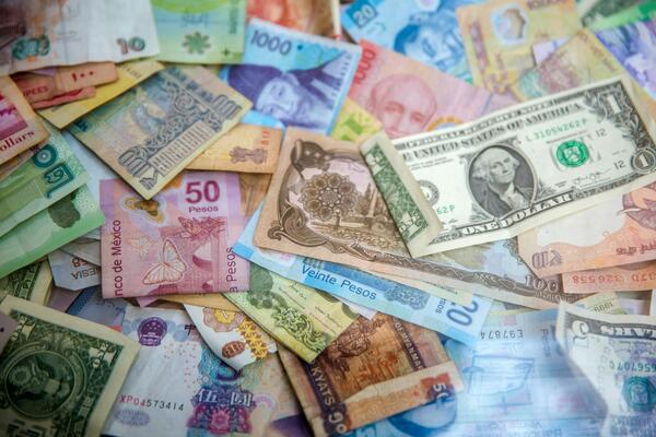 Different currencies spread out on a table